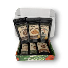 Box of Kauai Gourmet Nuts with various flavor packages on a white background