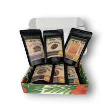 Box of Kauai gourmet nut packages with various flavors on a white background