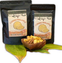 Two packages of Kauai Gourmet Nuts Curried Pineapple mixed nuts with a wooden bowl of nuts in front.
