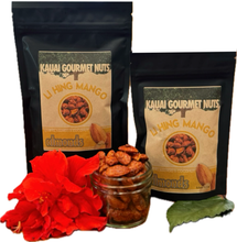 Two bags of Kauai Gourmet Nuts Lihing Mango Almonds with a jar of almonds and red flowers on a white background.