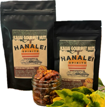 Two bags of Kauai Gourmet Nuts Hanalei Spirits Spiced Butter Rum with a jar of spiced nuts and flowers on a white background.