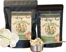 Two packages of Kauai Gourmet Nuts Salt & Vinegar mixed nuts with a small container of nuts and an orchid flower.